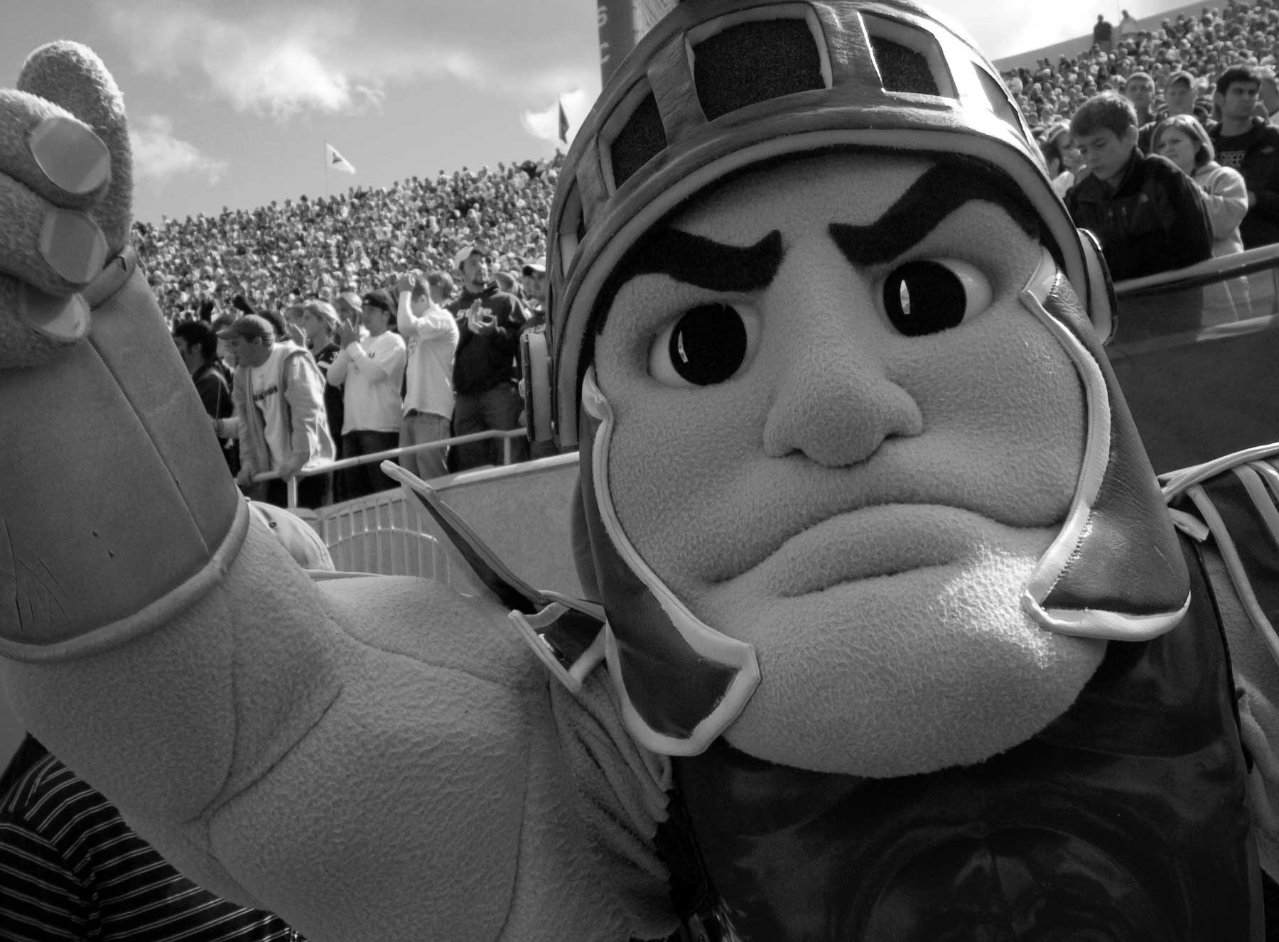 black and white photo of Sparty at a football game)